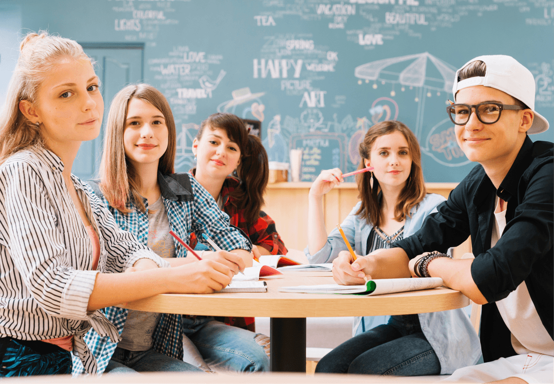 Group of adult students sitting on a table