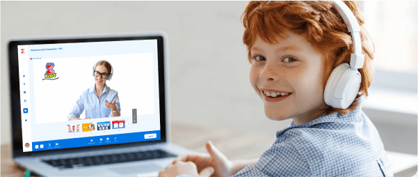 Boy smiling in front of a computer