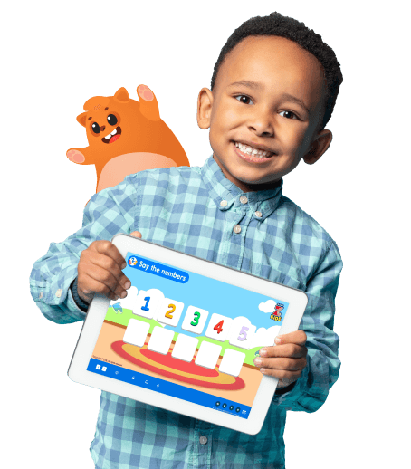 A kid smiling holding a tab that's teaching numbers