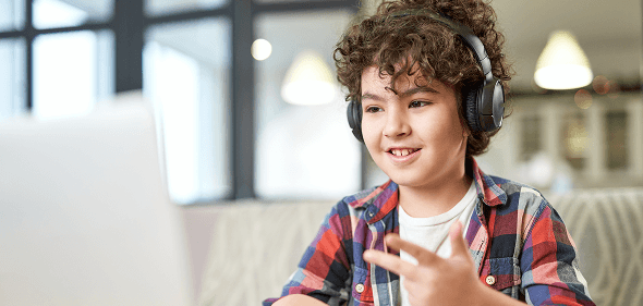 ZoniLive child engaged in online English education with a smile on computer