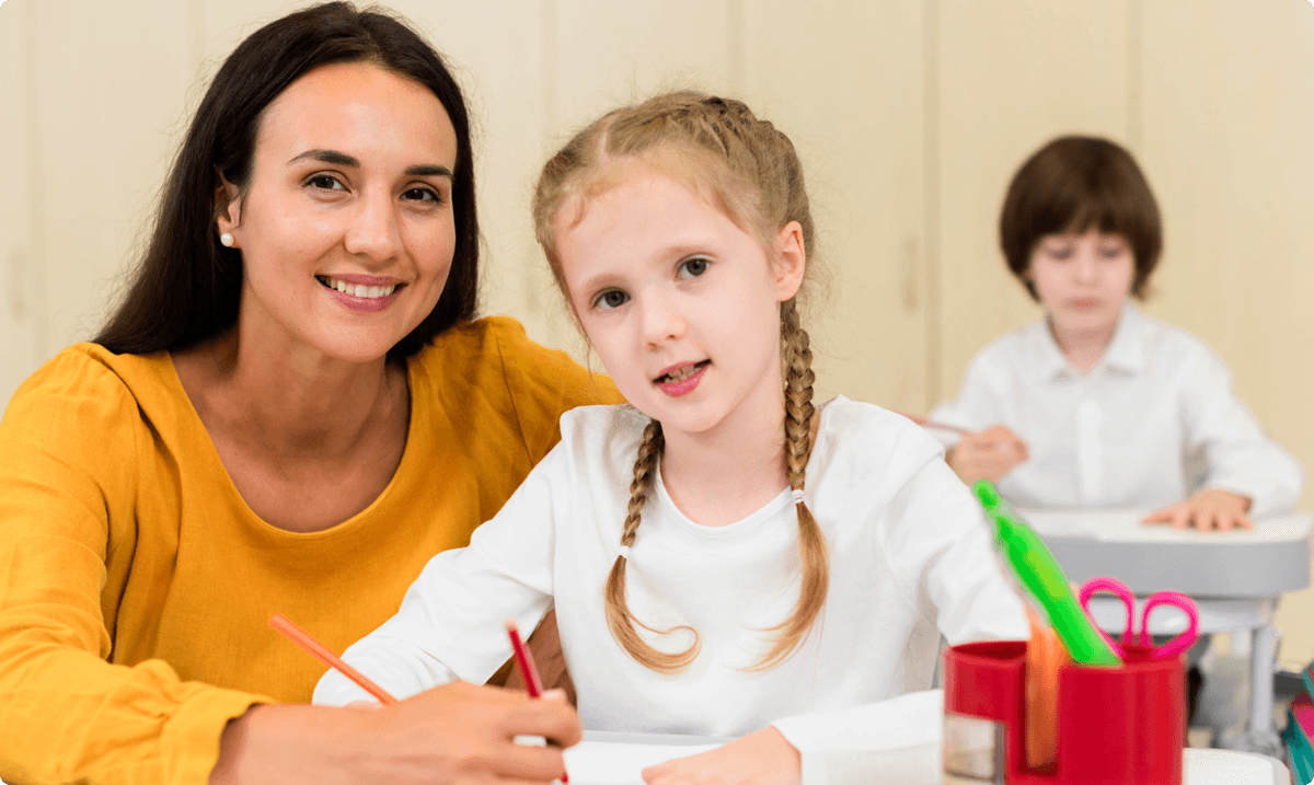 ZoniLive blonde kid and teacher smiling in an engaging learning environment