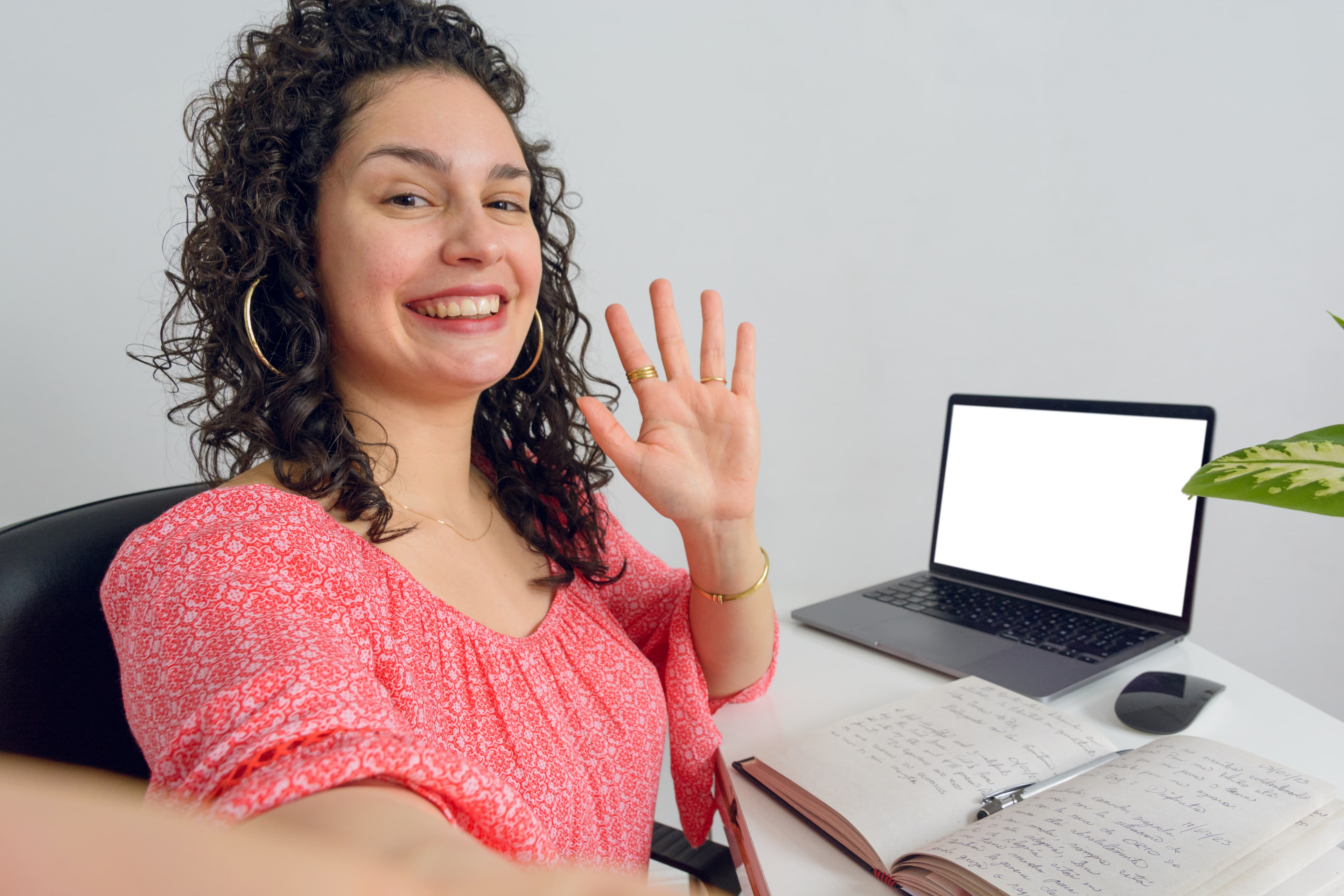 Student waving on camera