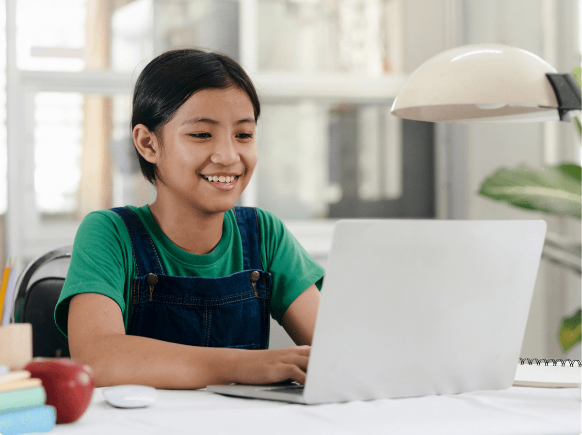 ZoniLive kid learning from a laptop, participating in engaging online classes for early education